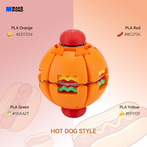 A hot dog style HelixCore Press-to-Spin Squishy Ball made of orange, red, yellow, and green plastic pieces, shown on a pink and peach gradient background with text labels for the colors.
